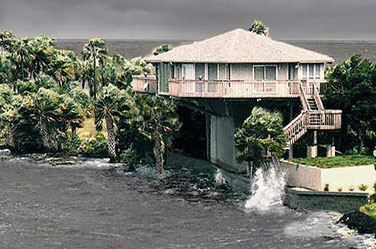 Topsider Hurricane-Proof Pedestal Home in Coastal Florida: Survived Years of Hurricanes, Tropical Storms, and Storm Surge with Unrivaled Strength and Luxury Topsider hurricane-resistant coastal Florida pedestal home surviving storm surge and waves during tropical storm or hurricane, elevated design for flood and wind protection with lush palm trees, oceanfront views, and sturdy construction.